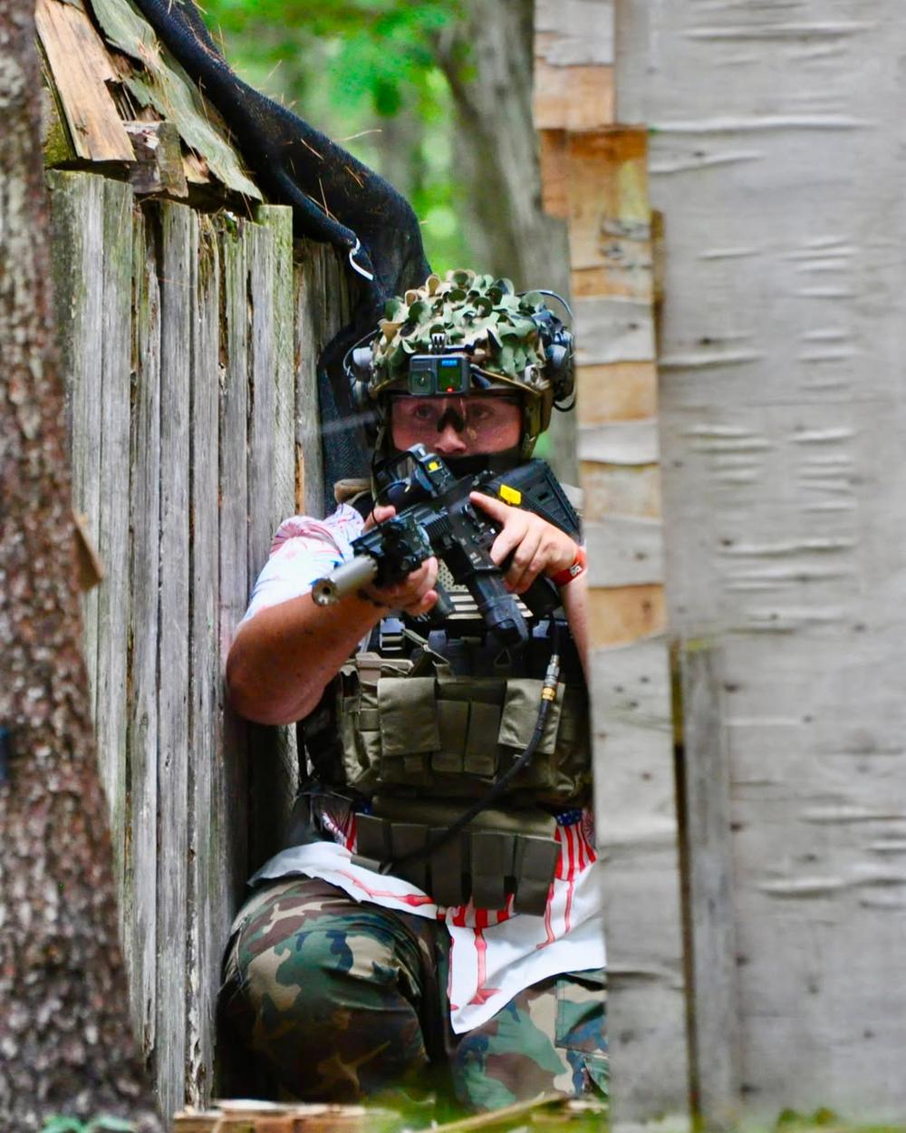 A player taking cover beside a wall on the field