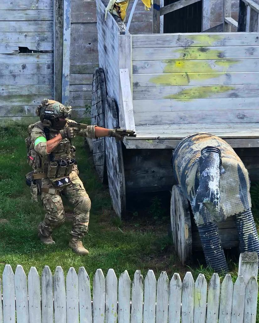 A player in full kit beside a vehicle in Ghost Town
